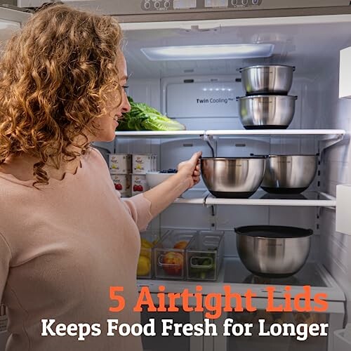 Woman placing airtight containers in refrigerator