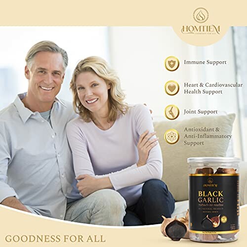 Couple smiling with black garlic product and health benefits listed.