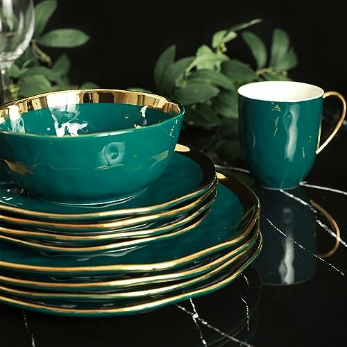 Elegant green and gold dinnerware set with a cup and plates