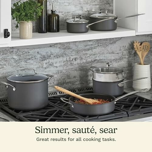 Cookware set on stove with pots and pans.